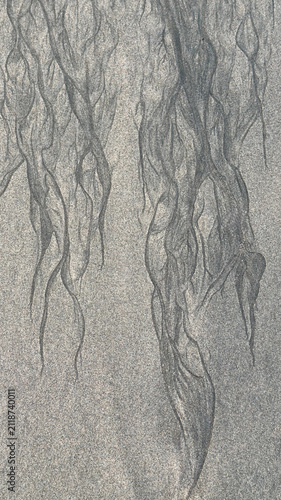 Abstract natural sand patterns formed by receding tide