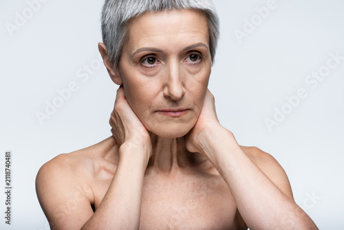 Принти на полотні Senior woman with short hair embracing beauty and self care in a serene setting
