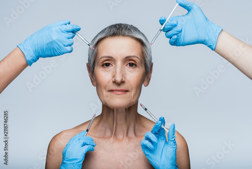 Cuadro en lienzo Senior woman experiencing beauty care with youthful revitalization techniques