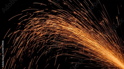 Orange welding spark shower isolated on black background