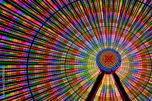 Colourful illuminated ferris wheel at night.