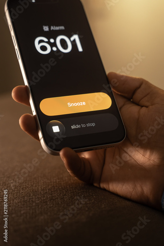 Canvas Print Hand Snoozing Alarm on Smartphone.
