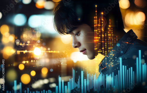 Asian businessman analyzing financial stock market charts and graphs