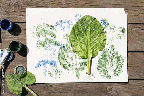 Fotografie Prints of various plants made with green and blue paint on white paper, using th