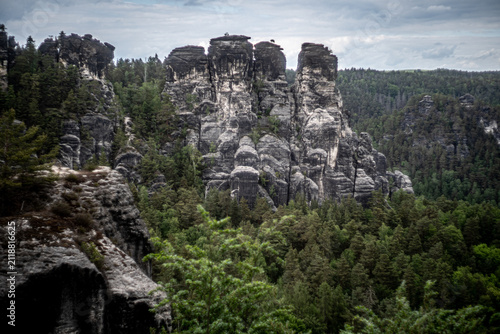 Fotografie Dramatic sandstone rock formations and forest landscape in Saxon Switzerland Nat