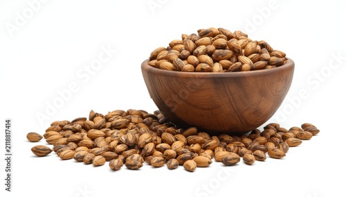 Wooden bowl with sunflower seeds on white background.