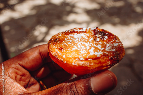 Hand holding Pastel de nata