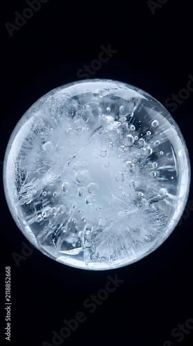 Abstract ice sphere with internal bubbles and fractures macro water reflection texture