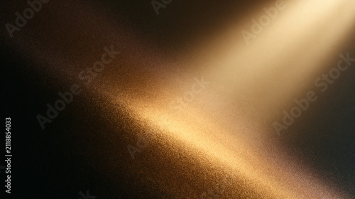 A bright golden beam of light shines across a dark textured background creating a soft glow and a dramatic atmosphere for a professional design project