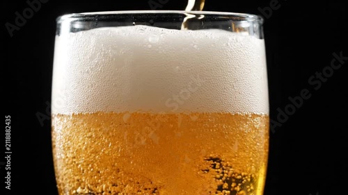 Refreshing Beer Poured into Glass with Frothy Head, Close-up