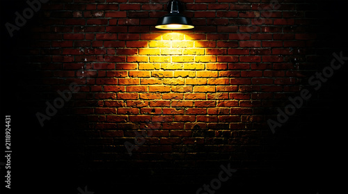 Warm light beam on red brick wall texture, dramatic contrast