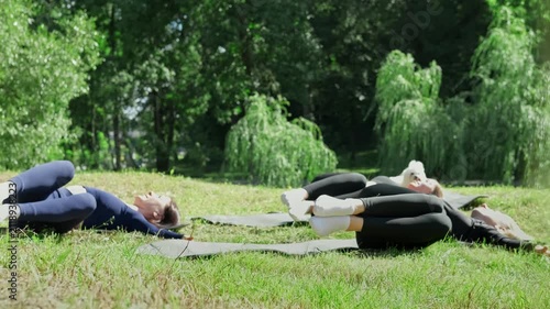 People enjoy healthy outdoor lifestyle. Sport training fitness workout. Females training in summer park. 4K, UHD