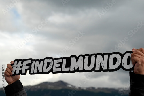 ushuaia fin del mundo sign holded by tourist