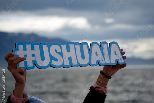 ushuaia sign holded by tourist