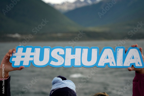 ushuaia sign holded by tourist