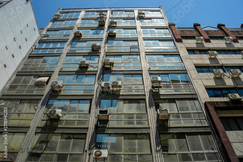 ac air conditioners outside windows of buenos aires modern building