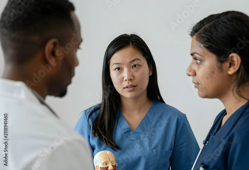 Diverse medical team discus...