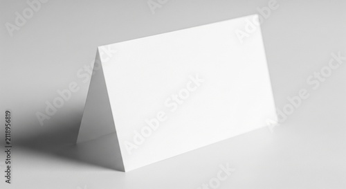 Blank white folded tent card mockup displayed on a clean neutral surface for professional branding and signage design presentation