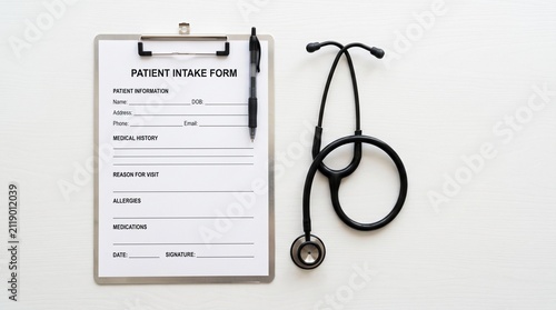 Patient intake form with stethoscope on white background.