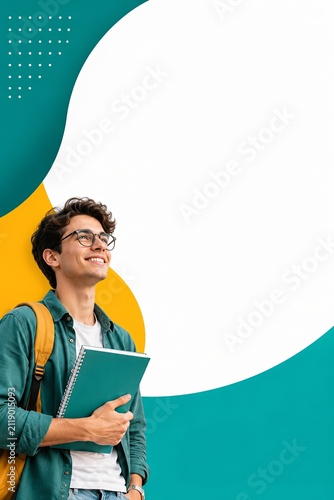 Smiling student holding notebook. Young man with backpack looking up at copy space.
