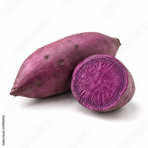 Fresh purple sweet potatoes, whole and sliced, displaying violet flesh