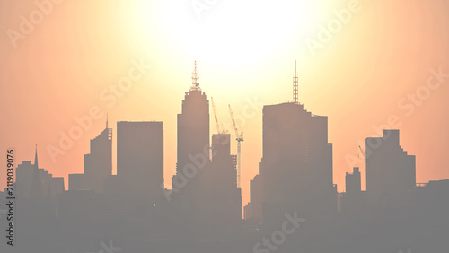 City Skyline Silhouette With Construction Cranes at Hazy Sunset