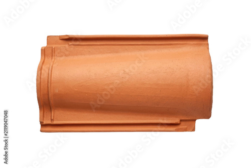 Traditional terracotta clay roof tile on black background.