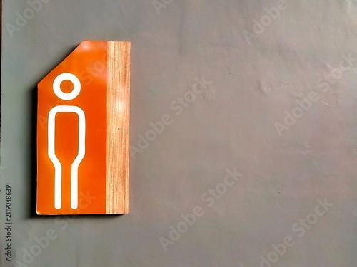 Male Toilet Direction Sign on Interior Wall with Orange and Wood Design