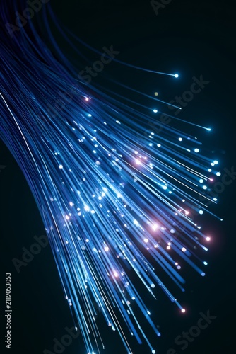 Fiber optic cables create light patterns in a dark setting during a technology showcase