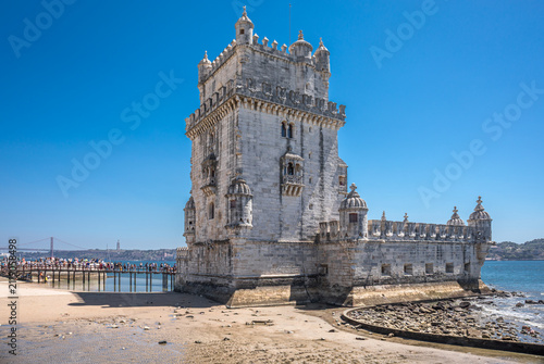 фотографія Iconic Belem Tower on the banks of the Tagus River at low tide with 25th of Apri