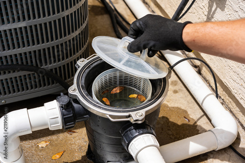Canvastavla Pool pump basket cleaning with gloved hand, debris removal for optimal function