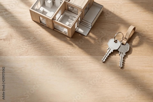 Modern House Model with Keys on Wooden Surface