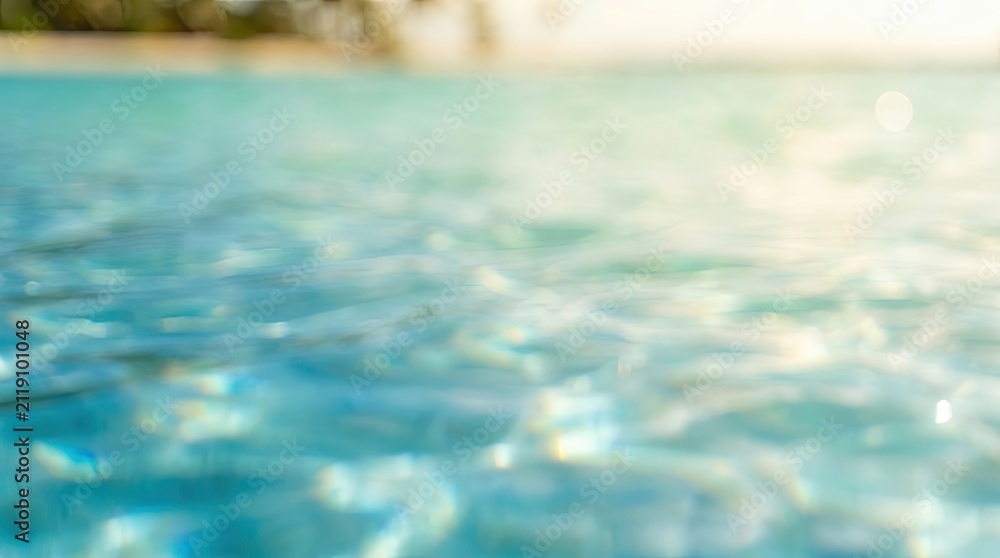 Fototapeta premium Abstract Blue Water Surface Background with Sparkling Light Reflections and Bokeh Effect