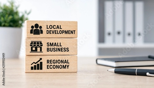 Stacked wooden blocks illustrating local development small business and regional economy concepts on a workspace surface