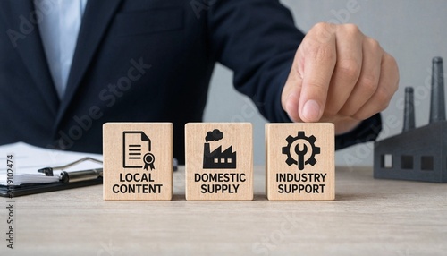 Professional hand pushing wooden blocks representing local content domestic supply and industry support concepts