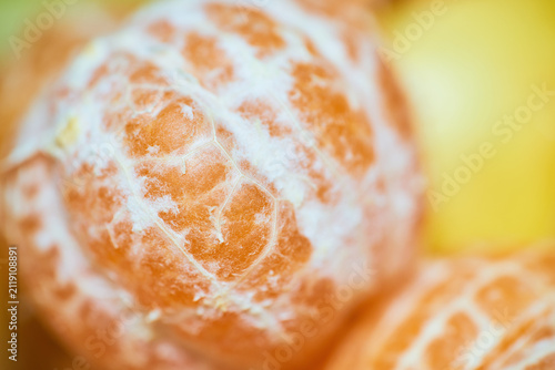Close-up macro shot of fresh juicy tangerine peel texture showing rich citrus fruit details