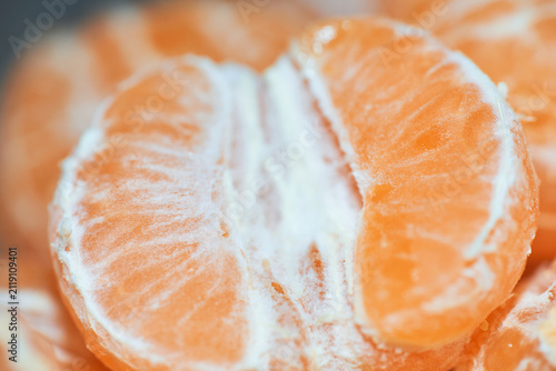 Фотография Close-up macro shot of peeled ripe tangerine segments showing vibrant orange cit