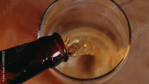Macro Close-Up of Hand Pouring Beer into a Pint Glass