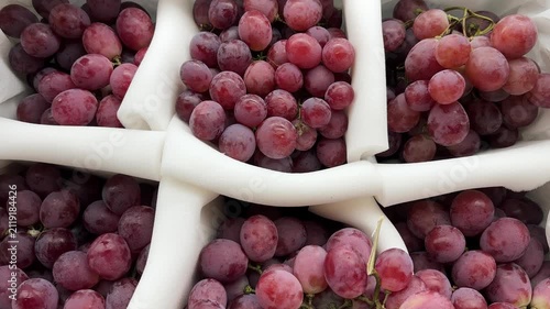 Fresh red grapes arranged neatly. A video showing the incredibly smooth movement of red grapes.