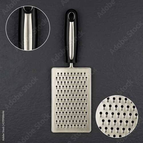 Stainless steel hand grater with ergonomic handle on dark background