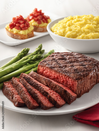 render of a gourmet lunch combo. A small appetizer plate of bruschetta is paired with a large plate of sliced grilled beef steak over mashed potatoes and asparagus. The arrangement is professional 