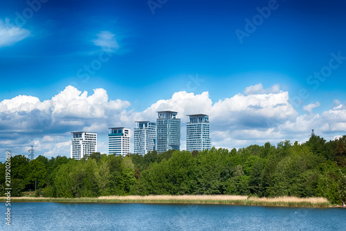 A modern skyline view of the Kalasatama district skyscrapers across the water from Mustikkamaa island in Helsinki, Finland, on a sunny, cloudless summer day. HDR.