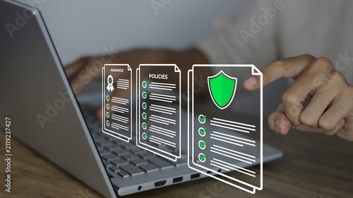 Reviewing digital insurance policy documents on a laptop with icons of insurance certificates, policy checklists, and shield protection for cybersecurity and corporate risk management verification