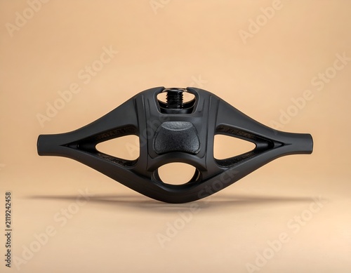 Matte black bicycle stem component isolated on a clean beige studio background