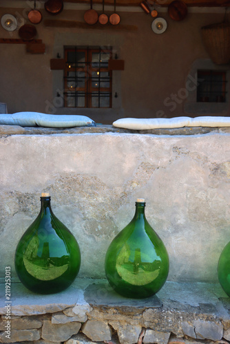 фотографія Traditional round glass bottles displayed on the Mediterranean street