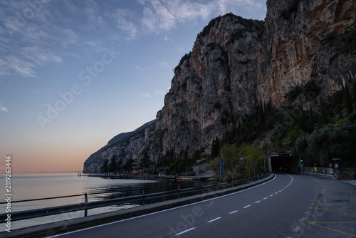 Scenic Lakeside Road Entering Tunnel Beneath Cliffs at Lake Garda, Italy