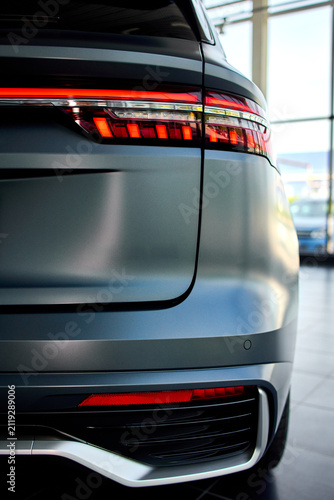 illuminated car tail lights at night close-up in modern automotive setting with glass and plastic materials and dynamic modern mood for in automotive and transportation.
