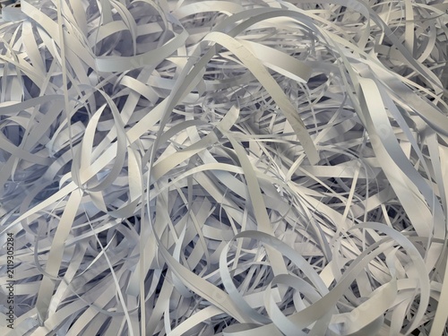 Close-up view of accumulated white paper waste filling frame, showing discarded material, dense texture and abstract background