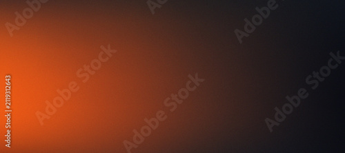 Glowing orange and black grainy gradient background texture