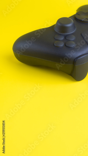 Vertical Close Up of Blank Black Gamepad Mockup on Yellow Background
